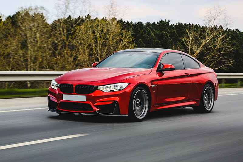 red-luxury-sedan-road